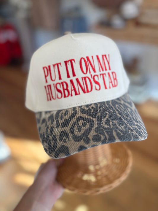 Put It On My Husbands Tab Trucker Hat